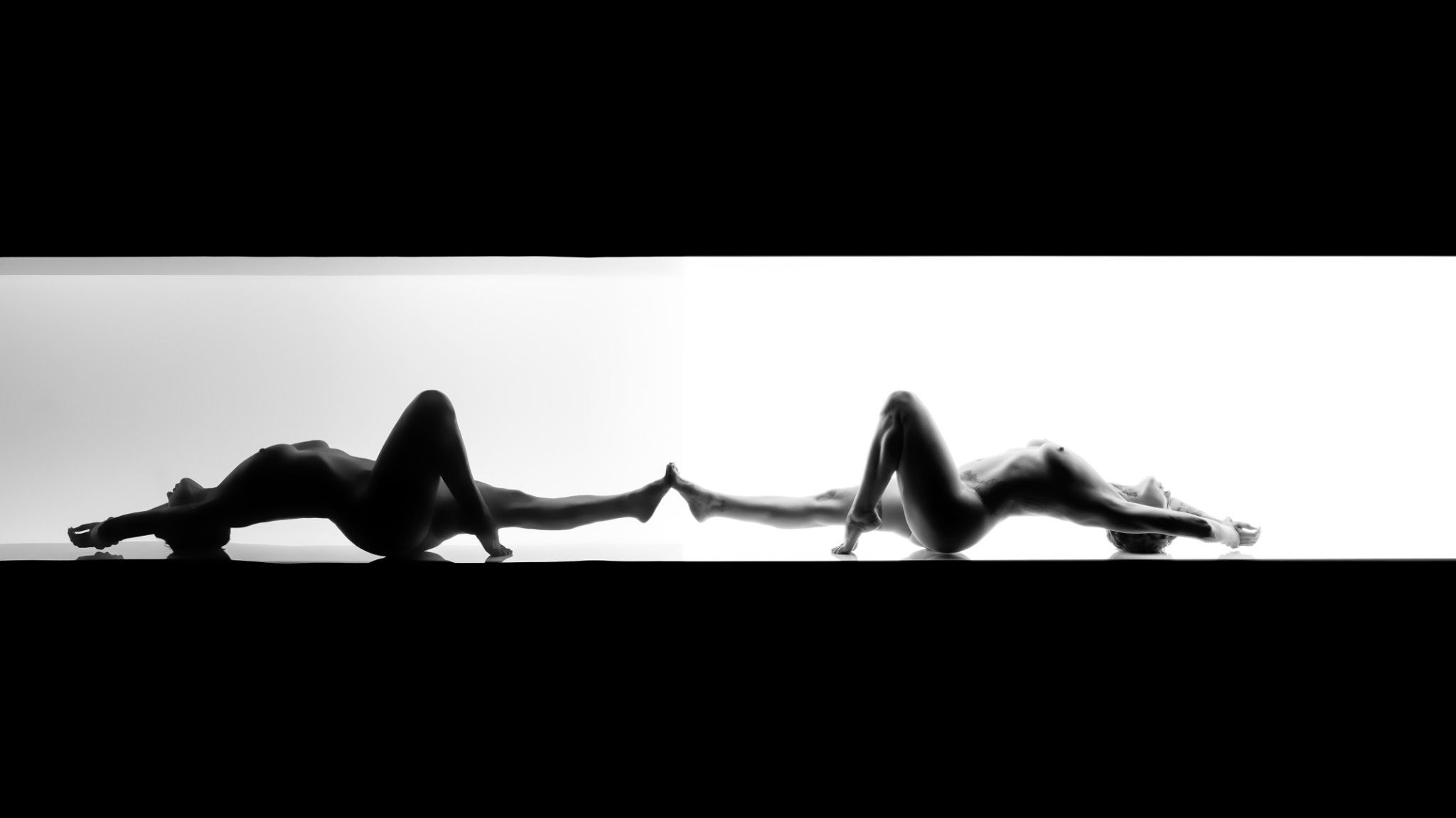 Black-and-white silhouette of RoXXXie and her reflection